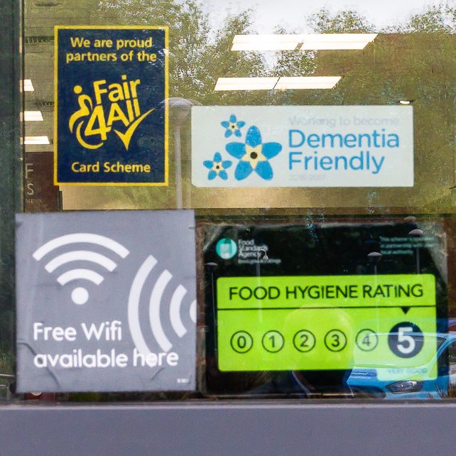 A Fair4All Card Partner sticker displayed in a shop window.