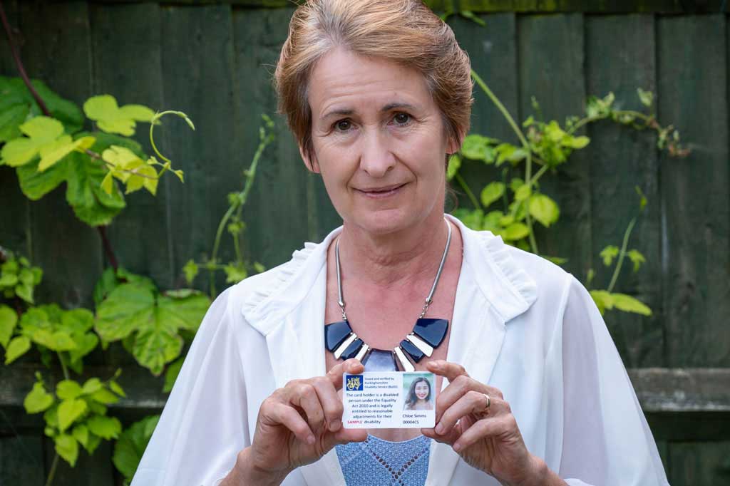 woman holding fair 4-all card